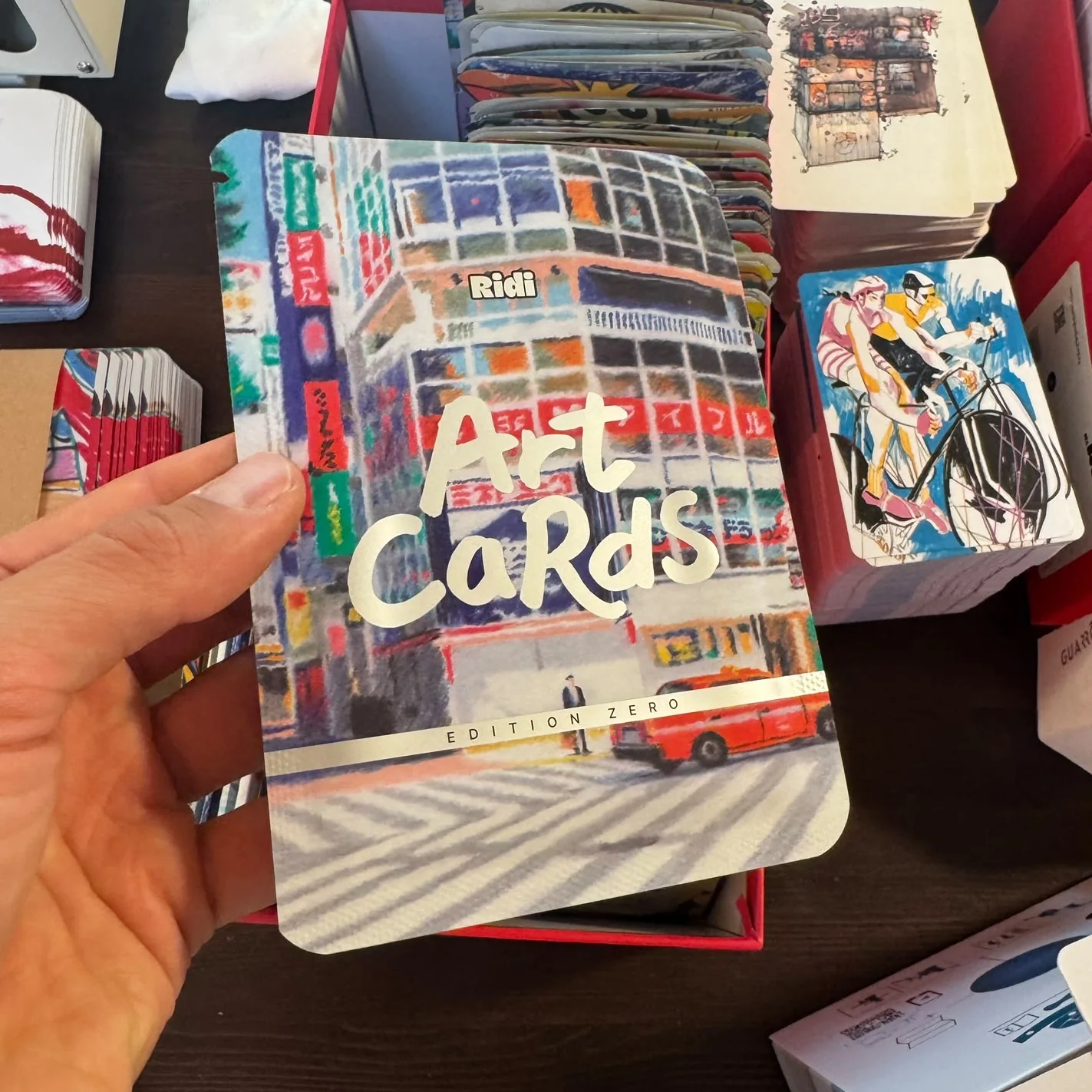An Edition Zero Art Cards pack held in hand